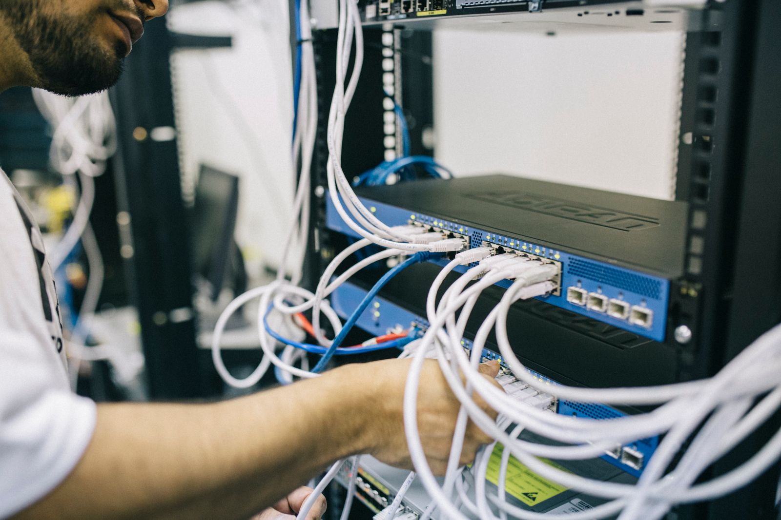 An engineer cabling servers in a rack